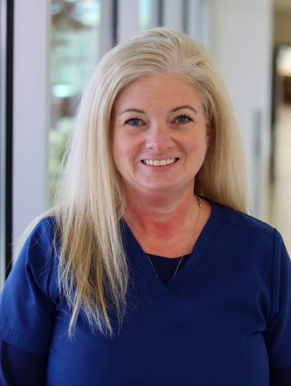 A team of nurses showing a certificate and enjoying their nursing careers.