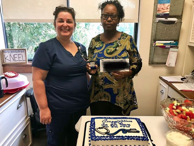 A longstanding Baptist Health employee being presented with a gift for 35 years as a Baptist Health employee
