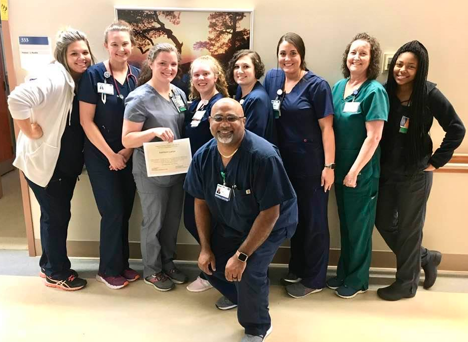 A team of nurses showing a certificate and enjoying their nursing careers.
